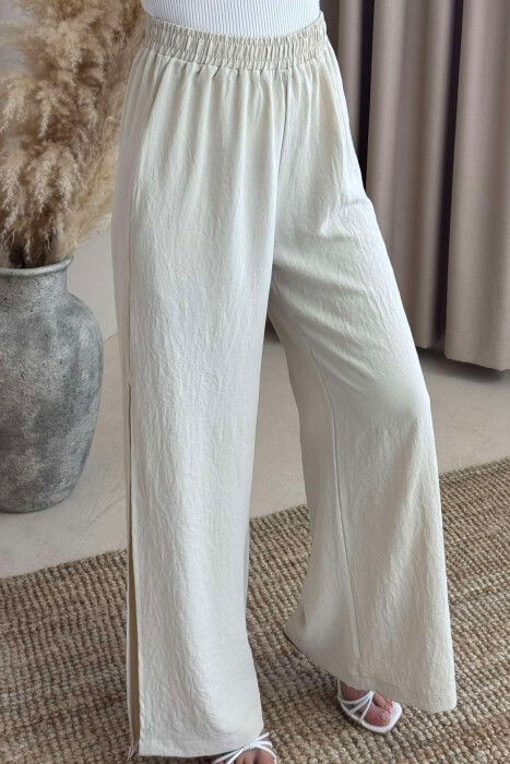 PANTALLONA NJË NGJYRËSHE TË GJERA PËR FEMRA NË NGJYRËN KREM - 2