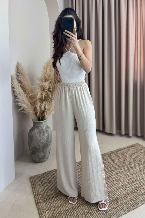 PANTALLONA NJË NGJYRËSHE TË GJERA PËR FEMRA NË NGJYRËN KREM 